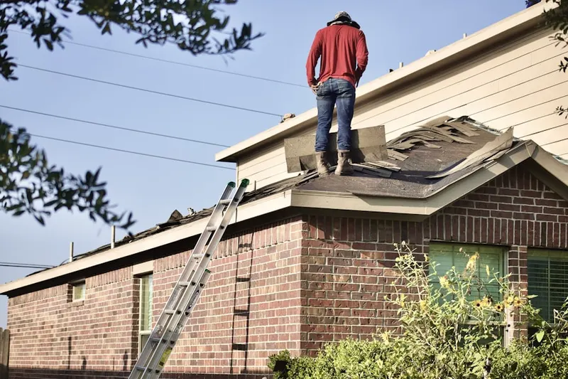 Professional roofer working on a residential roof in Kinter Crossing